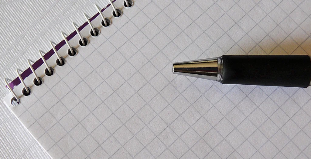 A pen and paper on a desk used for daily planning